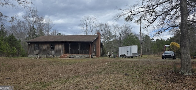 view of property exterior featuring crawl space and a chimney