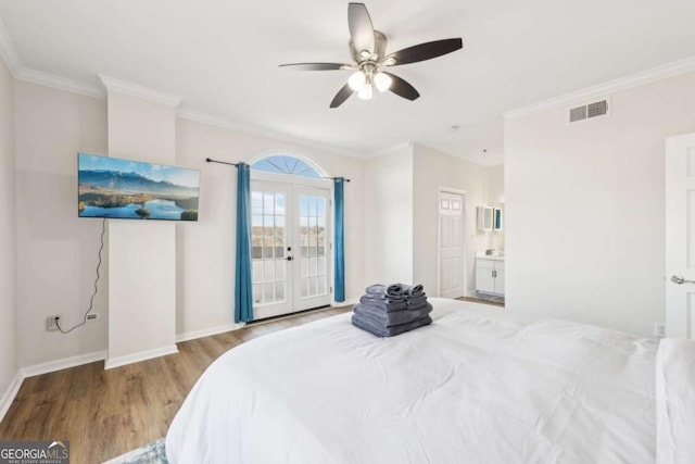 bedroom with french doors, visible vents, wood finished floors, and crown molding