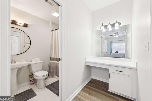 ensuite bathroom with ensuite bath, visible vents, toilet, and baseboards