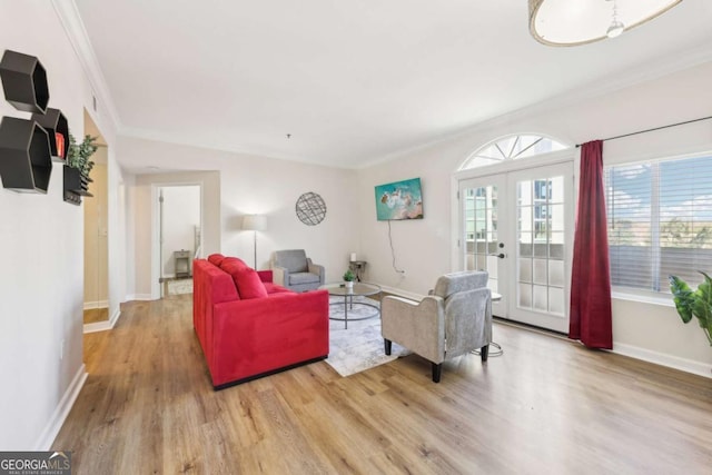 living room with french doors, baseboards, wood finished floors, and crown molding