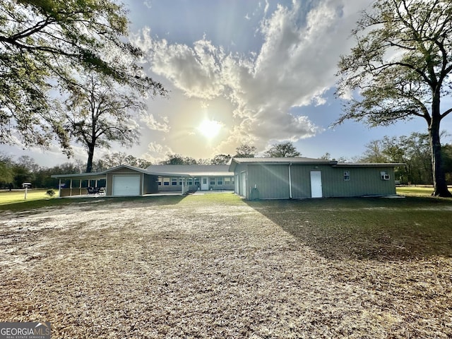 view of front of home with an attached garage and a front lawn