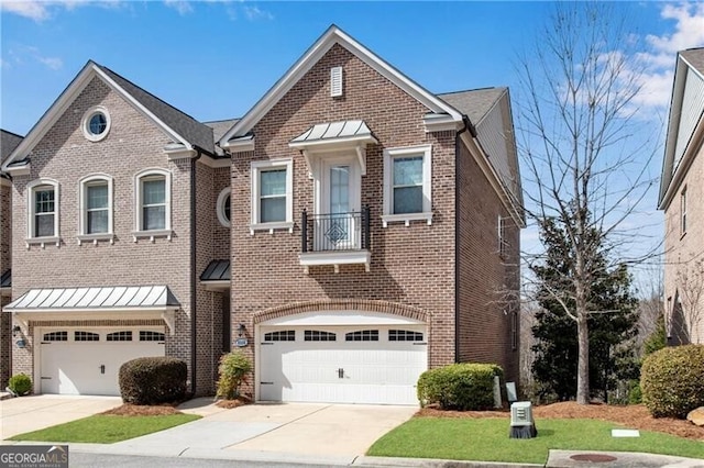 townhome / multi-family property with a standing seam roof, concrete driveway, a garage, and brick siding