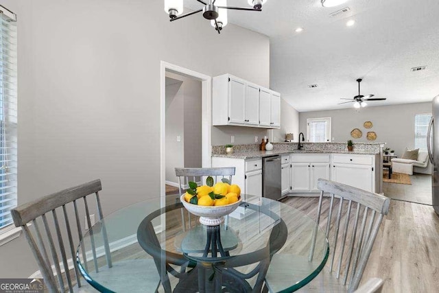 dining room featuring visible vents, plenty of natural light, baseboards, and light wood-style floors