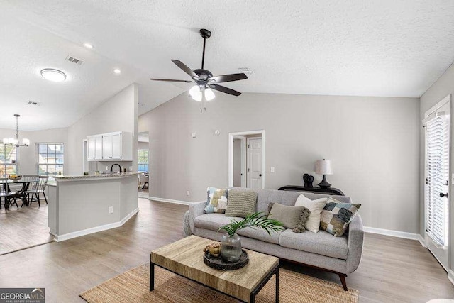 living room with visible vents, plenty of natural light, and light wood finished floors