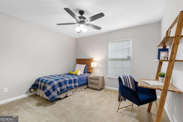 bedroom with carpet, baseboards, and a textured ceiling