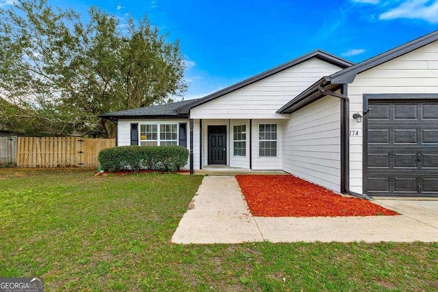 ranch-style home featuring a garage, a porch, a front yard, and fence