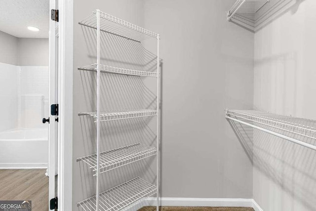 spacious closet featuring wood finished floors