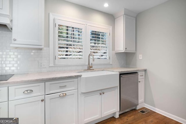 kitchen with tasteful backsplash, dishwasher, dark wood-style floors, white cabinetry, and a sink