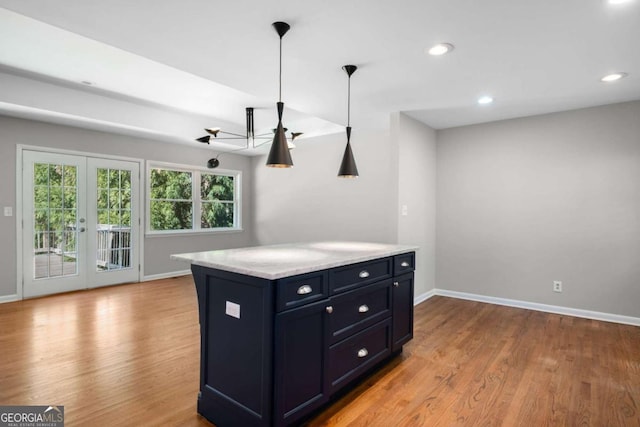 kitchen with wood finished floors, recessed lighting, french doors, and baseboards