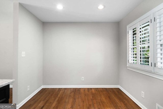 unfurnished room featuring dark wood finished floors, visible vents, recessed lighting, and baseboards