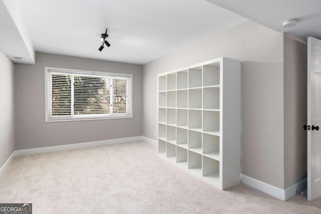 interior space with carpet flooring and baseboards