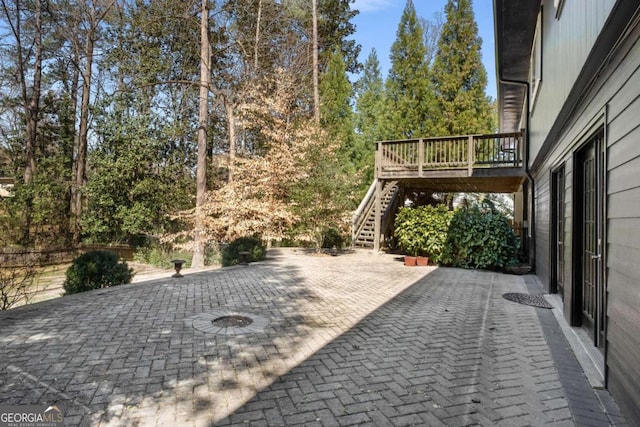 view of patio with stairway and a deck