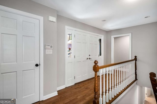 entrance foyer featuring baseboards and wood finished floors