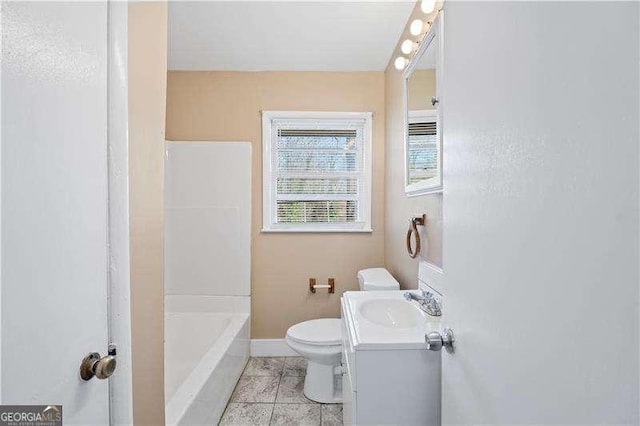 bathroom featuring vanity, tile patterned floors, toilet, and baseboards