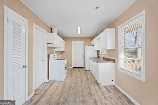 kitchen featuring baseboards, light wood-type flooring, white appliances, white cabinetry, and a sink