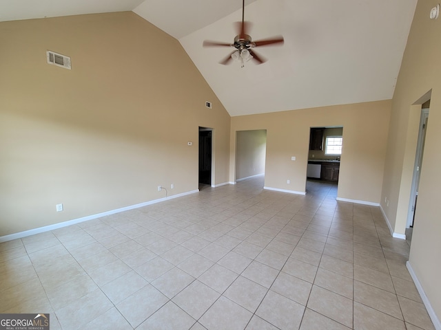 spare room featuring baseboards, a ceiling fan, visible vents, and high vaulted ceiling