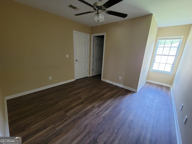 unfurnished bedroom with ceiling fan, visible vents, baseboards, and dark wood-style floors