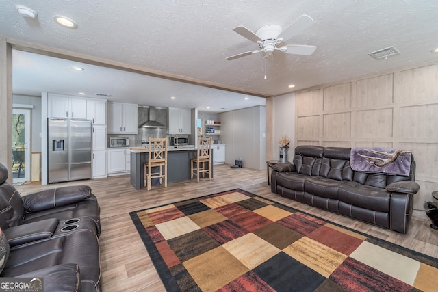 4159 Folks Dr, Blackshear, GA 31516 - living area featuring light wood finished floors, visible vents, recessed lighting, a decorative wall, and a textured ceiling