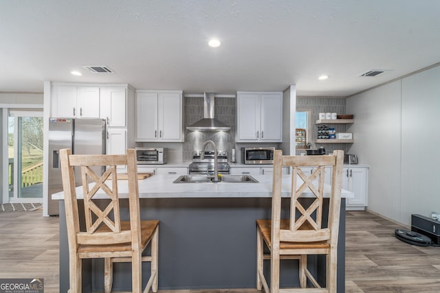 4159 Folks Dr, Blackshear, GA 31516 - kitchen featuring a sink, visible vents, appliances with stainless steel finishes, and wall chimney range hood