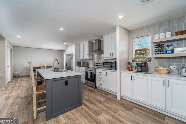 4159 Folks Dr, Blackshear, GA 31516 - kitchen with a sink, wall chimney range hood, light wood-type flooring, and stainless steel appliances