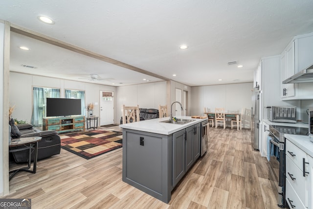 4159 Folks Dr, Blackshear, GA 31516 - kitchen with open floor plan, an island with sink, gray cabinets, appliances with stainless steel finishes, and a sink