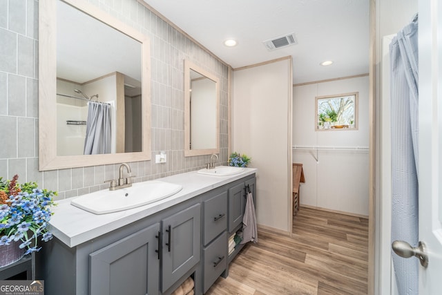 4159 Folks Dr, Blackshear, GA 31516 - full bath with tasteful backsplash, wood finished floors, visible vents, and a sink