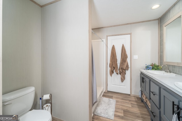 4159 Folks Dr, Blackshear, GA 31516 - bathroom with toilet, a sink, wood finished floors, double vanity, and walk in shower