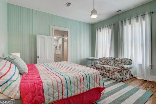 bedroom with visible vents and wood finished floors