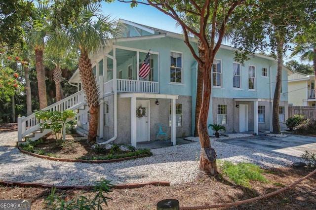 view of front of home featuring stucco siding and stairs