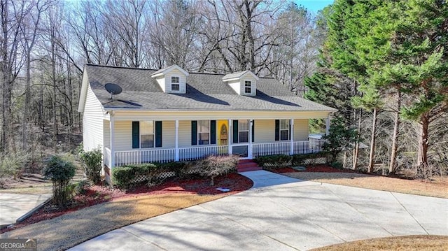 cape cod-style house featuring a porch