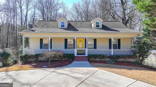 view of front of house featuring a porch and roof with shingles