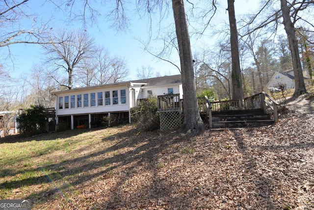 back of house with a deck and a sunroom