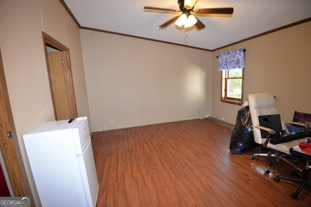 office area with a textured ceiling, wood finished floors, and ornamental molding