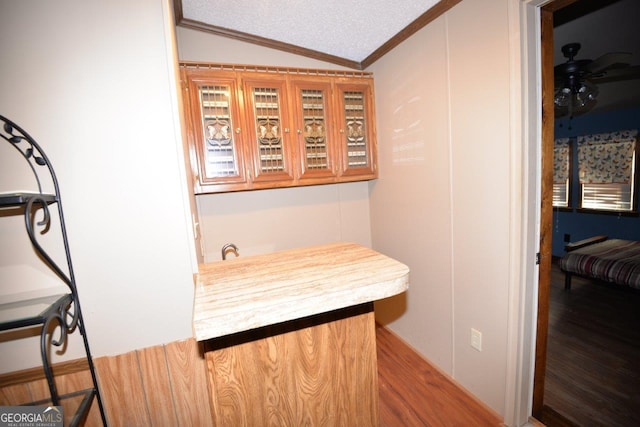 160 Cold Branch Rd, Eatonton, GA 31024 - bar featuring vaulted ceiling, wood finished floors, crown molding, and a textured ceiling