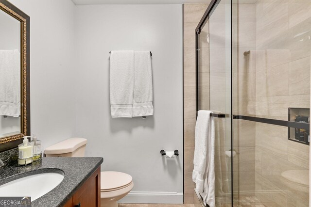 3203 Lenox Rd NE Unit 1, Atlanta, GA 30324 - bathroom with a stall shower, toilet, vanity, and baseboards