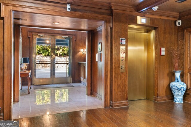 3203 Lenox Rd NE Unit 1, Atlanta, GA 30324 - interior space featuring hardwood / wood-style floors, beam ceiling, wooden walls, and french doors