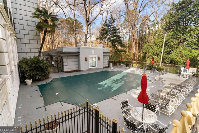 3203 Lenox Rd NE Unit 1, Atlanta, GA 30324 - community pool with a patio area, an outbuilding, and fence