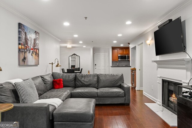 3203 Lenox Rd NE Unit 1, Atlanta, GA 30324 - living area with baseboards, dark wood finished floors, ornamental molding, recessed lighting, and a warm lit fireplace