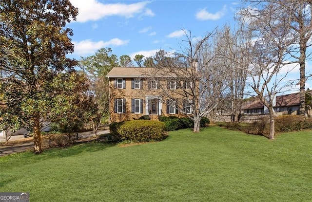 view of front of home featuring stone siding and a front yard