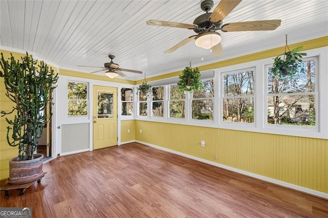 unfurnished sunroom with a wealth of natural light, wood ceiling, and ceiling fan