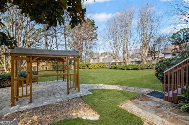 view of yard with a gazebo, fence, and a patio area