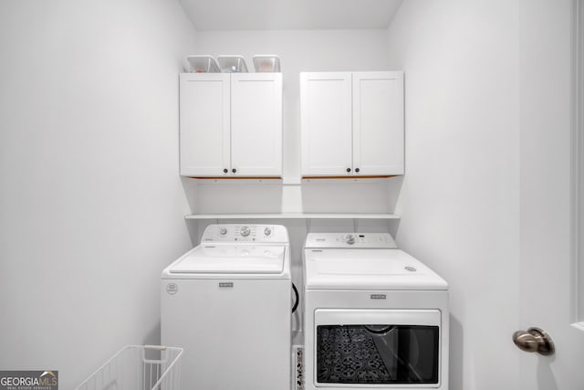 laundry area with cabinet space and washing machine and dryer