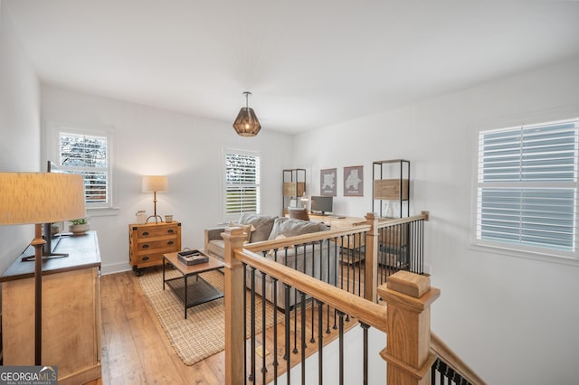 interior space with light wood-style flooring, multiple windows, and baseboards