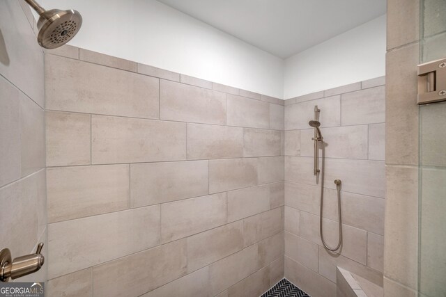 full bath with a tile shower