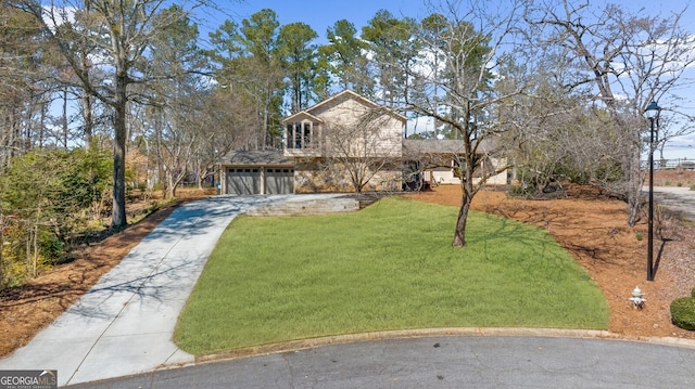 view of front facade featuring a front lawn and concrete driveway