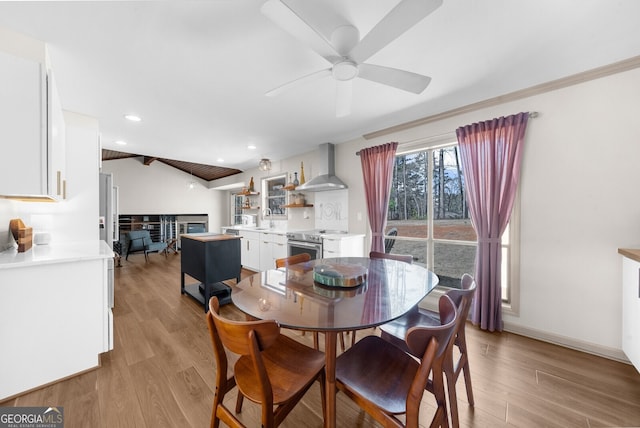 dining room with light wood-type flooring, a ceiling fan, recessed lighting, baseboards, and lofted ceiling