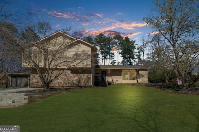 exterior space with a lawn, driveway, and a garage