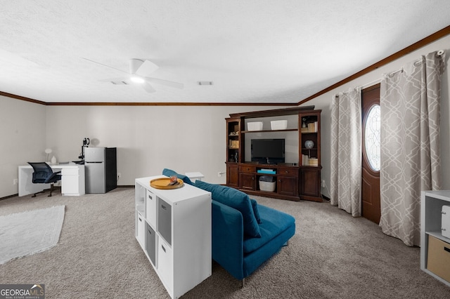 living area featuring visible vents, crown molding, ceiling fan, light carpet, and a textured ceiling