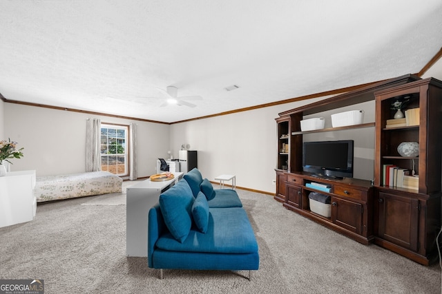 living area with visible vents, ornamental molding, baseboards, light colored carpet, and ceiling fan