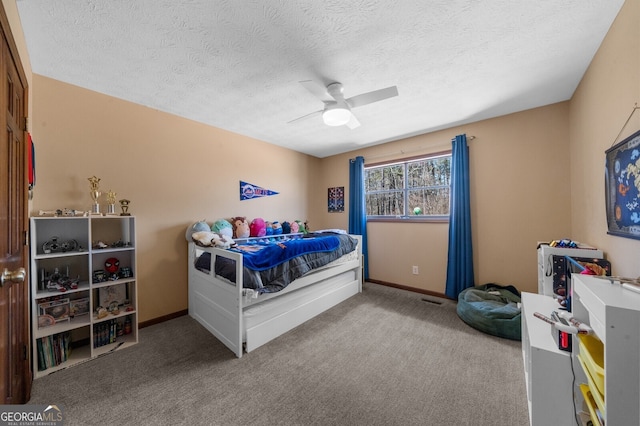 carpeted bedroom featuring baseboards, a ceiling fan, visible vents, and a textured ceiling